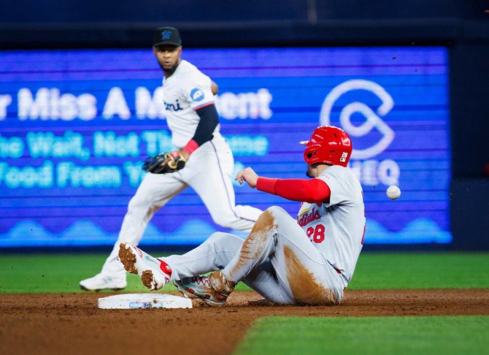 St. Louis Cardinals third baseman Nolan Arenado (28) slides in safe to second after Miami Marlins shortstop Tim Anderson (7) and second baseman Otto Lopez (61) miss the ball during the second inning of a baseball game on Wednesday, June 19, 2024 at loanDepot Park in Miami, Fla.