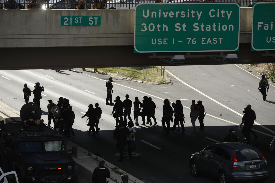 FILE—In this file photo from June 1, 2020, protesters march down Interstate 676 in Philadelphia, during a march calling for justice over the death of George Floyd. Three class-action lawsuits filed in Philadelphia on Tuesday, July 14, accuse the city of using military-level force against peaceful demonstrators protesting racial inequality and police brutality. (AP Photo/Matt Rourke, File)