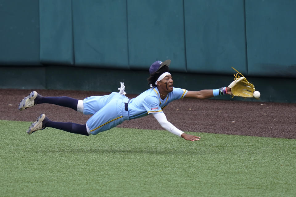 Southern centerfielder Isaiah Adams dives for a hit by Texas' Mitchell Daly in the second inning of an NCAA regional tournament college baseball game, Friday, June 4, 2021, in Austin, Texas. (AP Photo/Eric Gay)