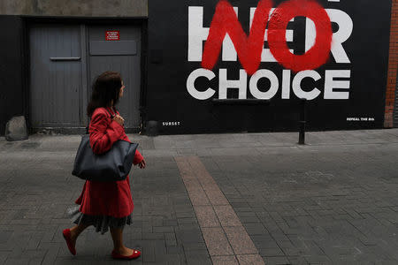 A woman walks past a new Pro-Choice mural by a graffiti artist collective called 'Subset' ahead of a 25th May referendum on abortion law, in Dublin, Ireland May 22, 2018. REUTERS/Clodagh Kilcoyne