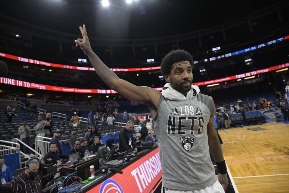 Brooklyn Nets guard Kyrie Irving acknowledges fans after a game against the Orlando Magic in March.