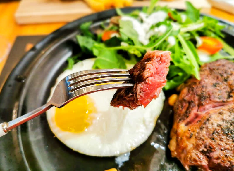 A piece of steak cut from Steak & Eggs