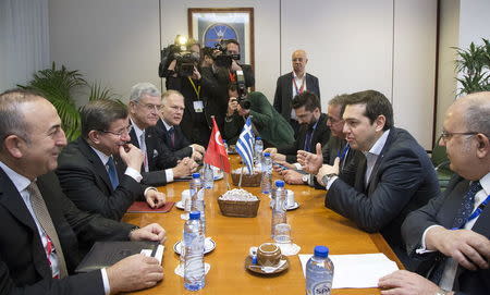 Greek Prime Minister Alexis Tsipras (2nd R) and Turkish Prime Minister Ahmet Davutoglu (2nd L) attend a bilateral meeting ahead of an EU-Turkey summit as the bloc is looking to Ankara to help it curb the influx of refugees and migrants flowing into Europe, in Brussels March 7, 2016. REUTERS/Yves Herman
