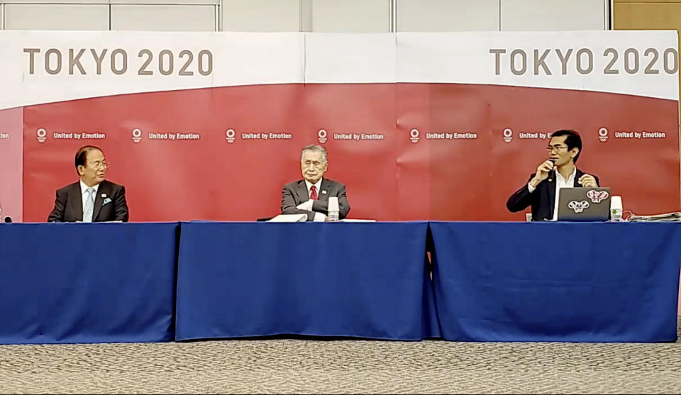 In this image made from video provided by Tokyo 2020 Official YouTube Channel, Tokyo 2020 Olympics President Yoshiro Mori, center, with CEO Toshiro Muto, left, attends a press conference after an IOC executive board meeting in Tokyo, Wednesday, June 10, 2020. (Tokyo 2020 Official YouTube Channel via AP)