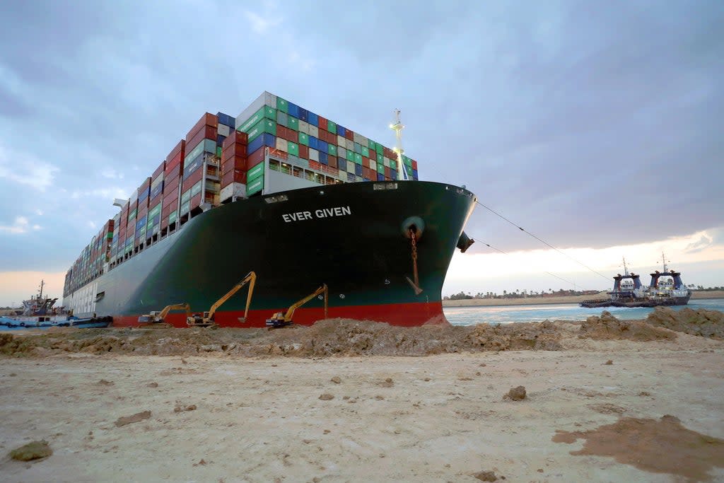 Salvage specialists make use of the high spring tide to excavate the Ever Given’s stern from the bank of the Suez Canal (EPA)