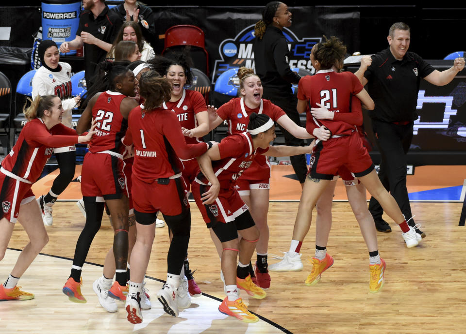 North Carolina State celebrates a win over Texas in an Elite Eight college basketball game in the women's NCAA Tournament, Sunday, March 31, 2024, in Portland, Ore. (AP Photo/Steve Dykes)