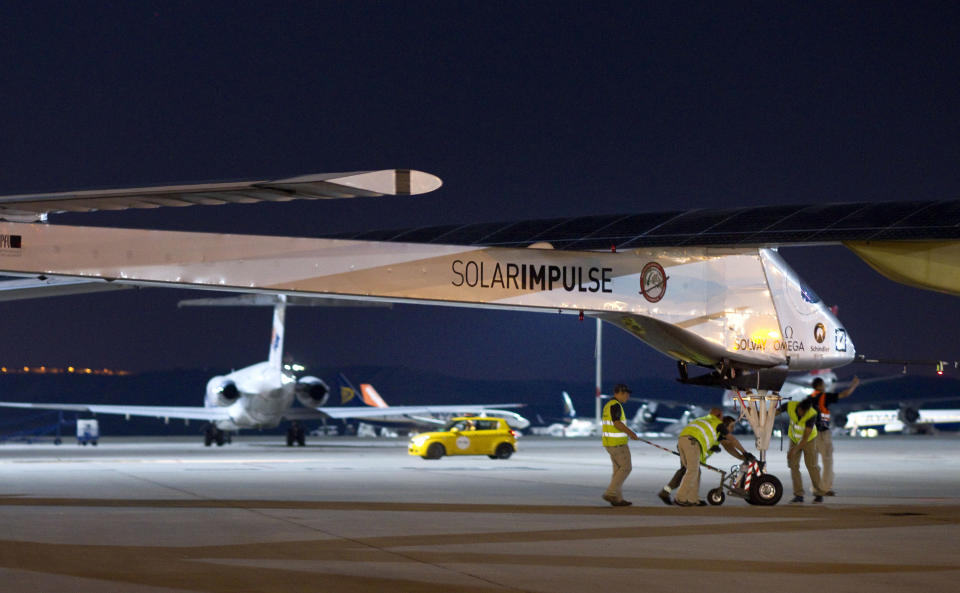 The Solar Impulse HB-SIA experimental aircraft is pulled out a hanger at Barajas airport in Madrid, Spain, Tuesday, June 5, 2012. The solar-powered airplane arrived in Madrid on May 25, 2012 from Payerne, Switzerland, and now goes on to Rabat, Morocco on its first transcontinental trip. The mission is described as the final dress rehearsal for a round-the-world flight with a new and improved aircraft in 2014. (AP Photo/Alberto Di Lolli)