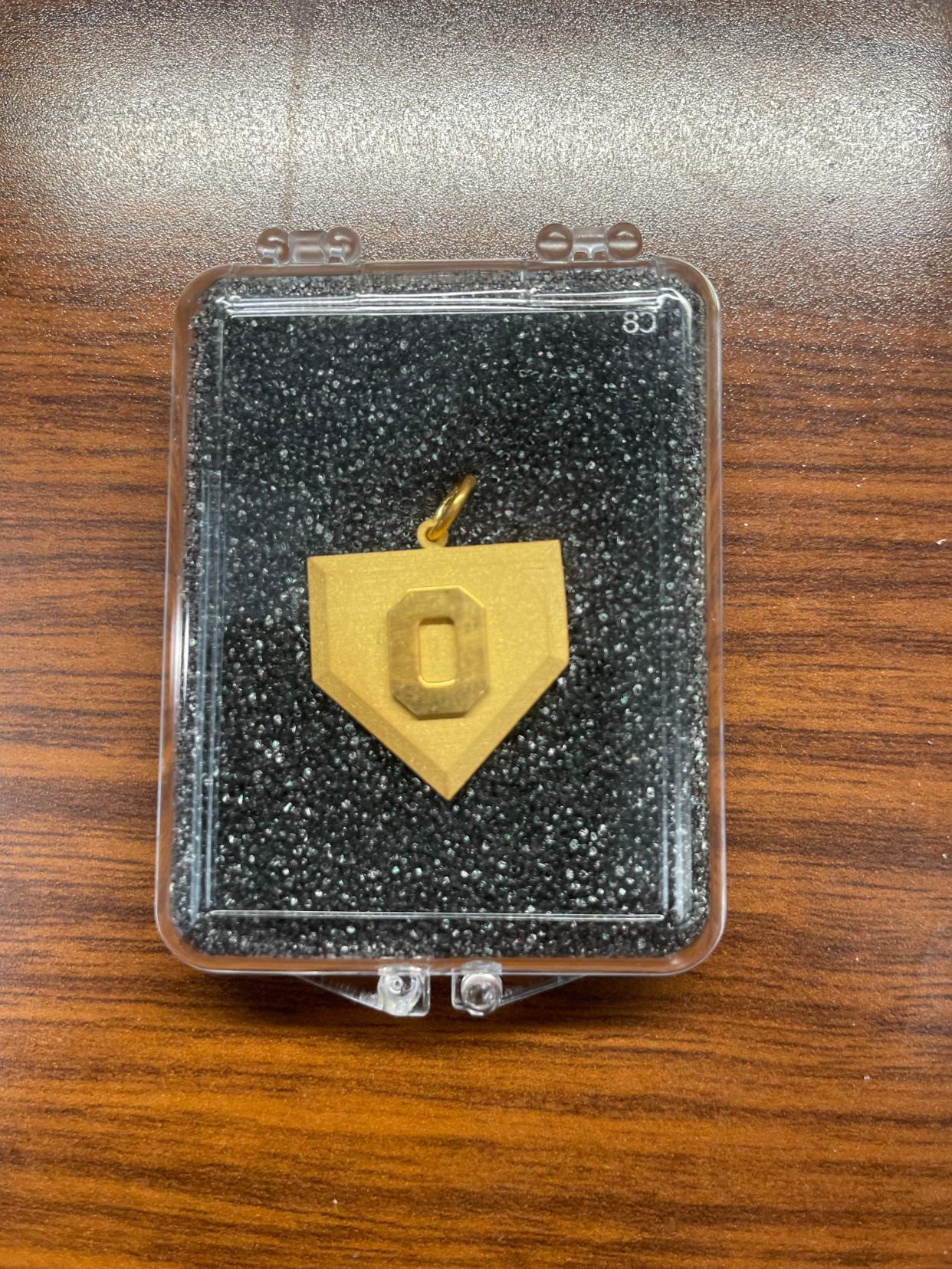 The Ohio State "Gold Home Plate" charm is given to each member of the softball team after a series win against Michigan.