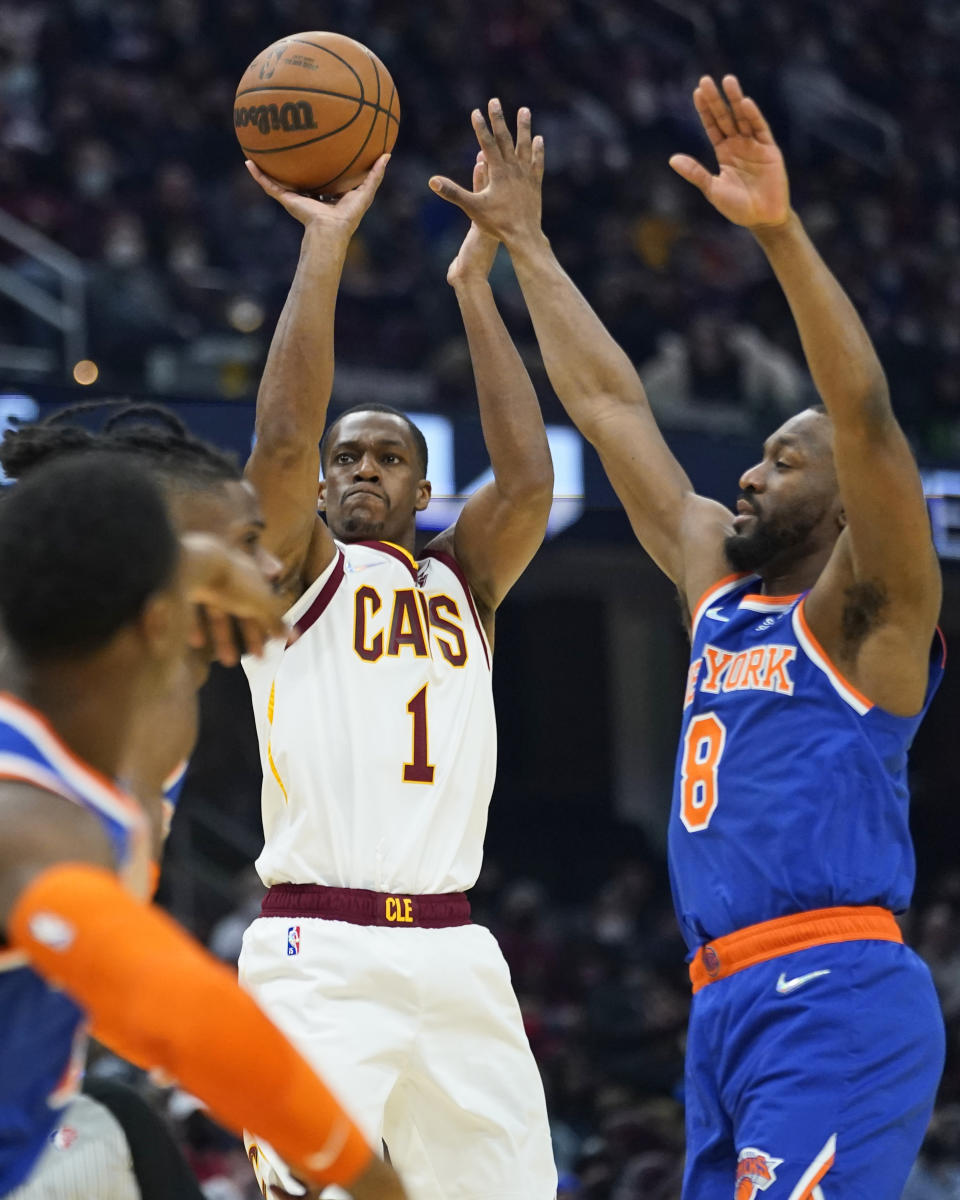 Cleveland Cavaliers' Rajon Rondo (1) shoots against New York Knicks' Kemba Walker (8) in the first half of an NBA basketball game, Monday, Jan. 24, 2022, in Cleveland. (AP Photo/Tony Dejak)