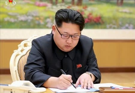 North Korean leader Kim Jong Un signs a document regarding the test of a hydrogen bomb, in this file still image taken from KRT video and released by Yonhap on January 6, 2016. REUTERS/Yonhap/Files