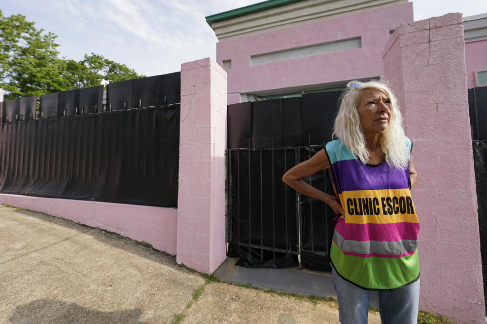 FILE - Derenda Hancock, co-organizer of the "Pink House Defenders," stands outside the Jackson Women's Health Organization, Mississippi's last remaining abortion clinic, also known as the "Pink House", May 3, 2022, in Jackson, Miss. Mississippi is one of the poorest states in the nation, and women would face even steeper hurdles to have access to abortion — arranging time off work, finding ways to pay for travel and lodging and, in many cases, arranging for child care while they are gone. (AP Photo/Rogelio V. Solis, File)