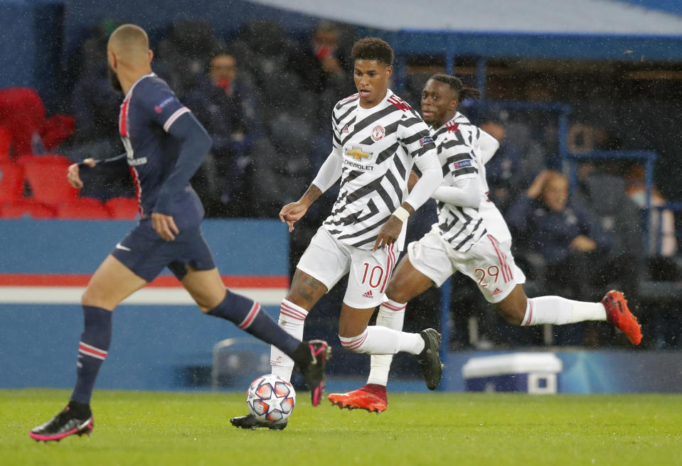 Manchester United's Marcus Rashford runs with the ball during the Champions League group H soccer match between Paris Saint-Germain and Manchester United at the Parc des Princes in Paris, France, Tuesday, Oct. 20, 2020. (AP Photo/Michel Euler)