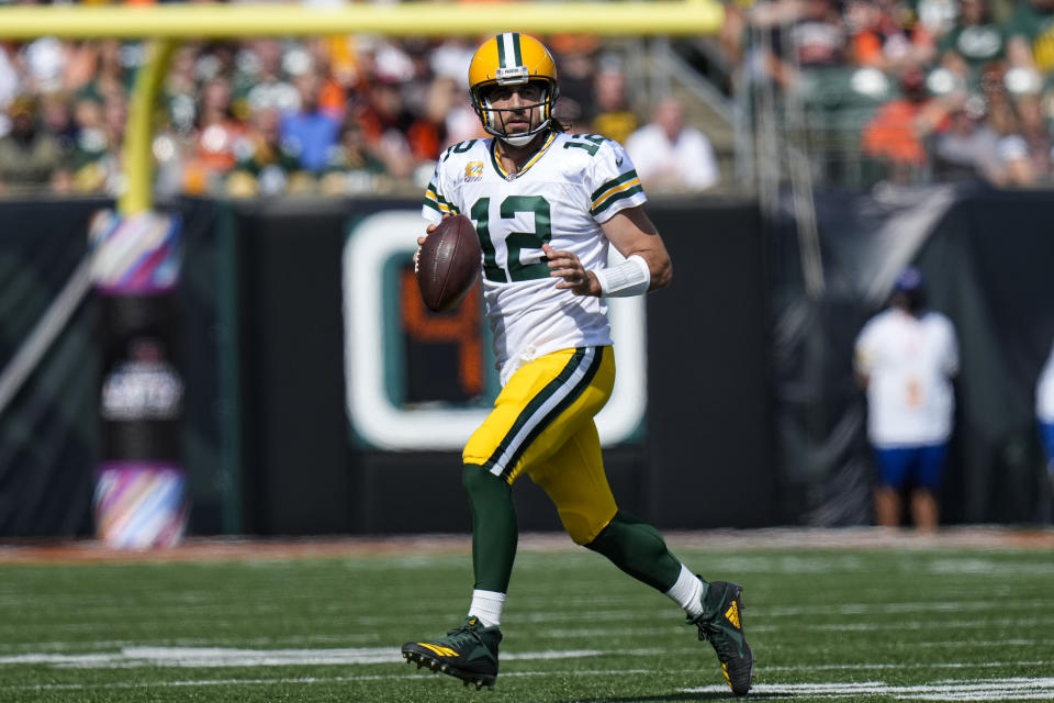 Green Bay Packers quarterback Aaron Rodgers (12) scrambles in the first half of an NFL football game against the Cincinnati Bengals in Cincinnati, Sunday, Oct. 10, 2021. (AP Photo/AJ Mast)