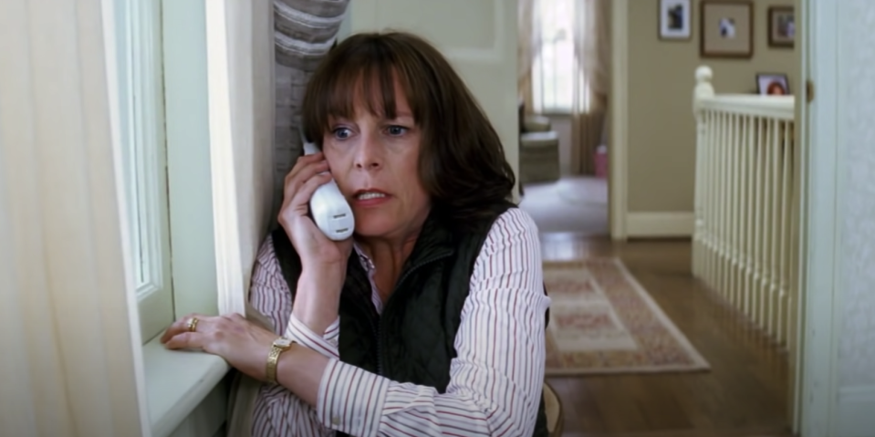 A woman frantically talks on the phone