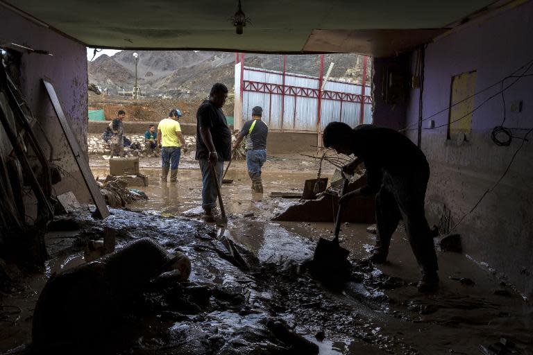 A man cleans his house after heavy rainfall caused the Copiapo River to flood parts of Copiapo, Chile, March 26, 2015