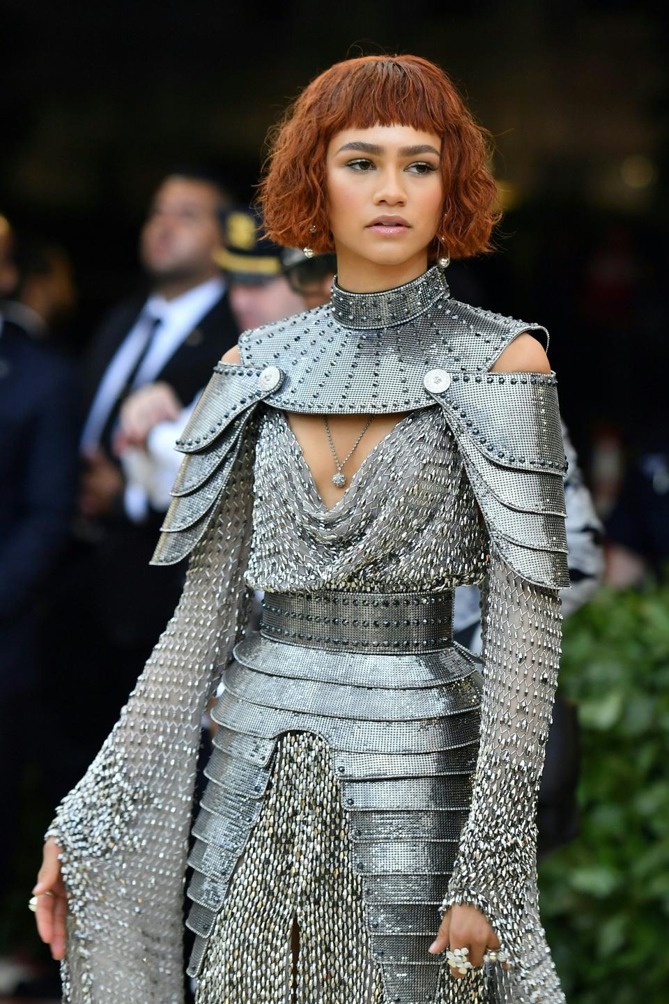 Zendaya in a metallic armor-inspired gown with shoulder details