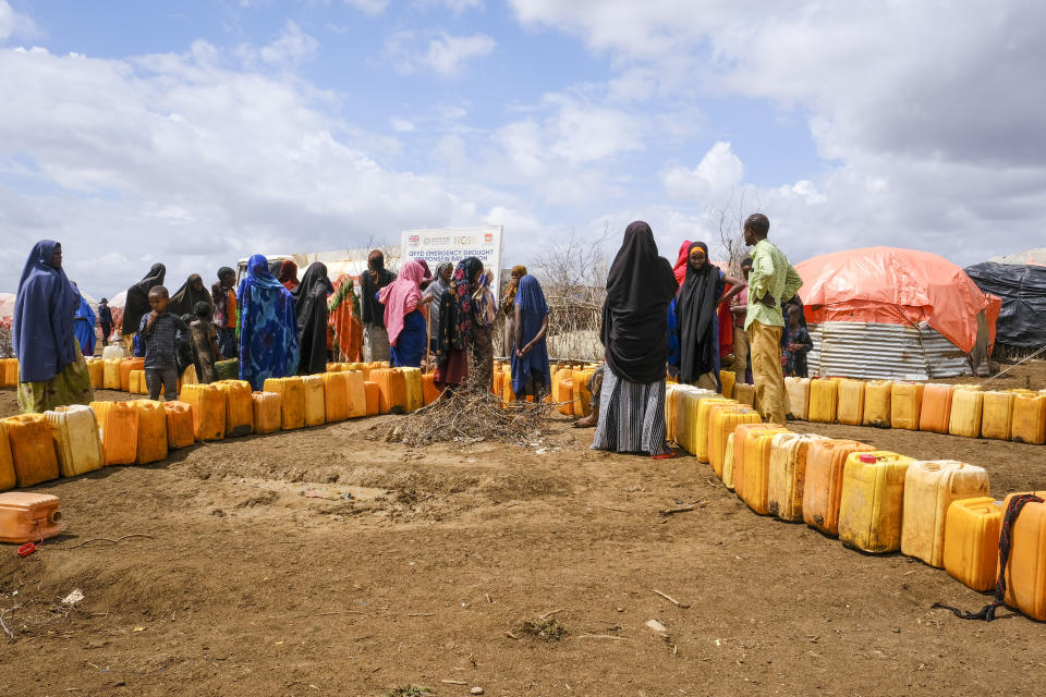 FILE - Somalis displaced by drought wait in line to fill jerrycans with water distributed by the Norwegian Refugee Council, on the outskirts of Baidoa, in Somalia, Oct. 29, 2022. The world is falling well short of the progress needed to meet the United Nations’ sustainable development goals by 2030 in areas ranging from poverty to clean energy to biodiversity, according to a report Tuesday, June 20, 2023, from the nonprofit tracking the goals. (AP Photo/Mohamed Sheikh Nor, File)