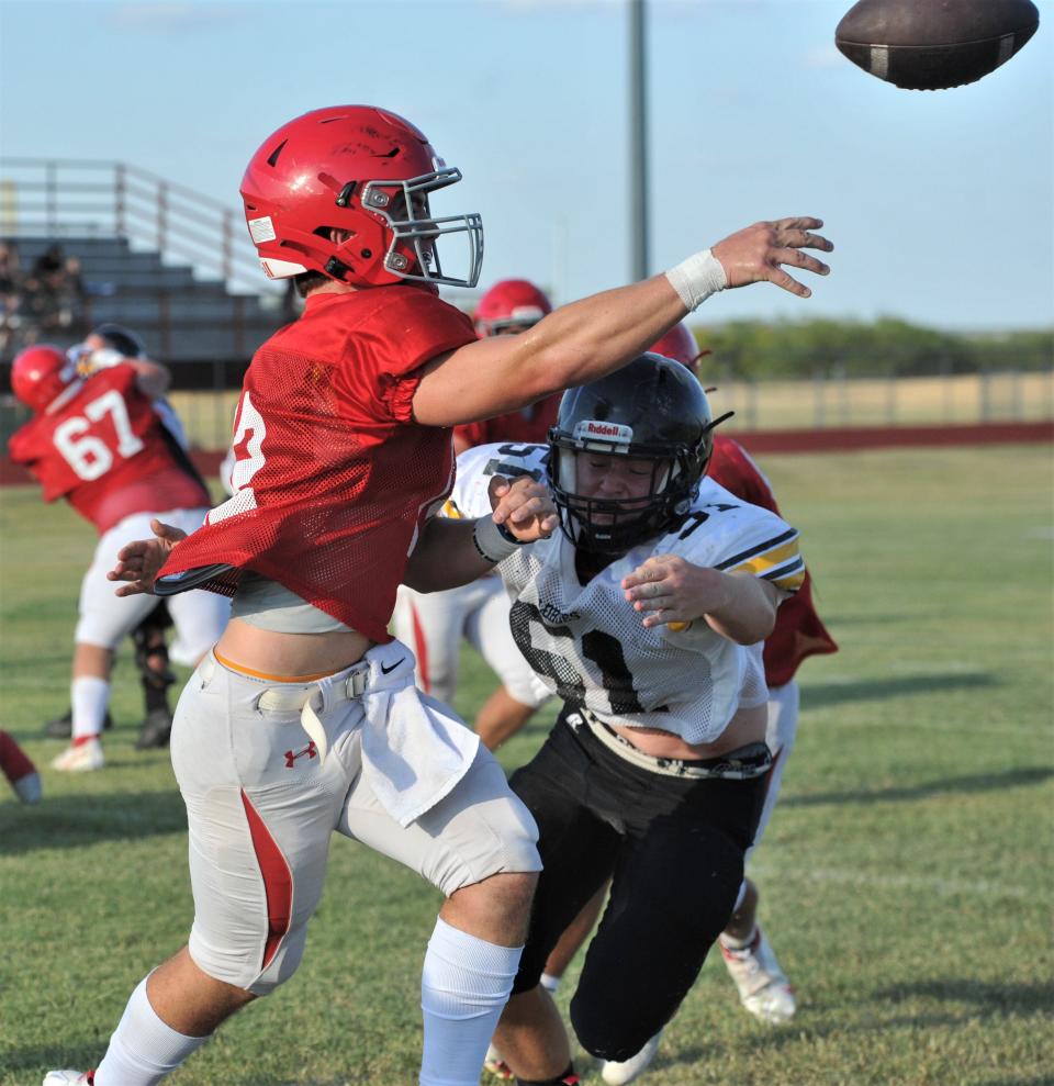 Holliday's Peyton Marchand throws the ball before being hit by a Cisco defender during a scrimmage against Cisco on Friday, August 12, 2022.