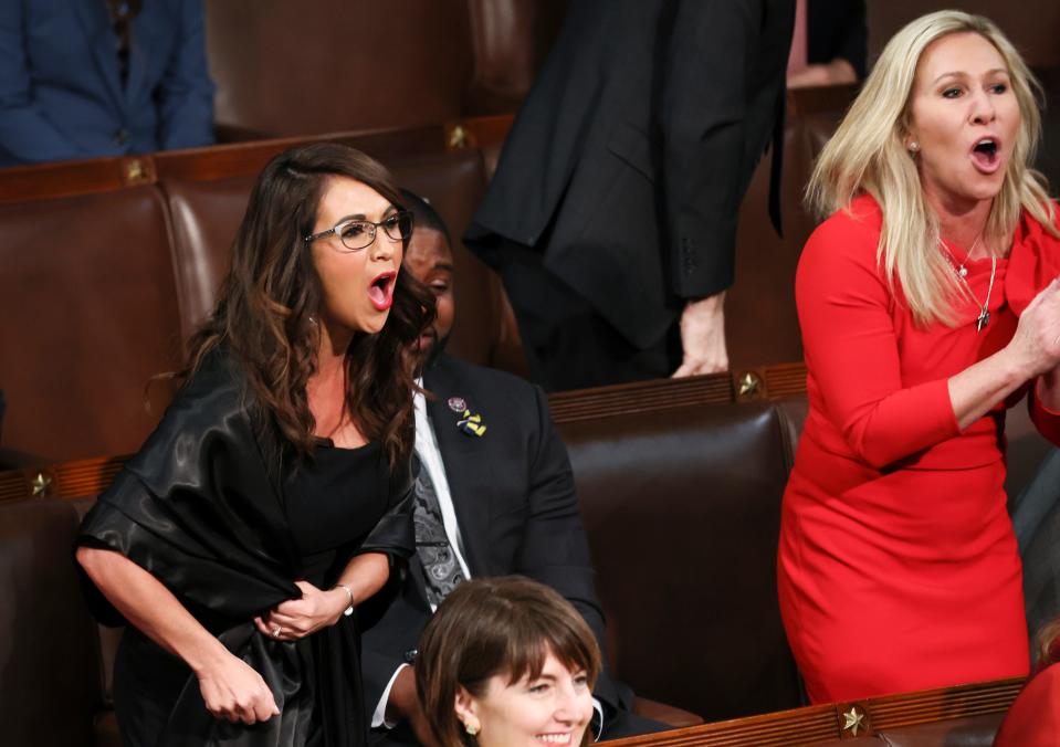 Rep. Lauren Boebert, R-Colo., left, and Rep. Marjorie Taylor Greene, R-Ga., right, scream "Build the Wall" as President Joe Biden delivers his first State of the Union address.