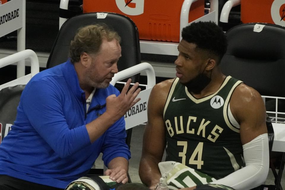 Milwaukee Bucks head coach Mike Budenholzer talks to Giannis Antetokounmpo during the first half of Game 3 of the NBA Eastern Conference basketball semifinals game against the Brooklyn NetsThursday, June 10, 2021, in Milwaukee. (AP Photo/Morry Gash)