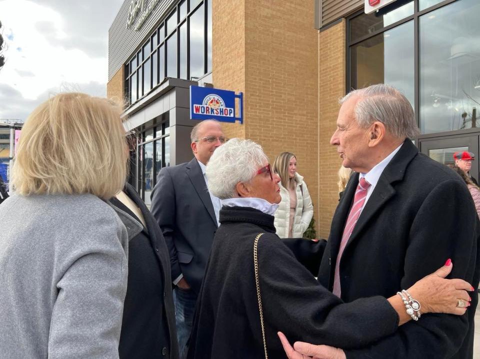 Stark County Commissioner Janet Creighton greets Canton Mayor Thomas Bernabei on Friday at the opening of a new Visit Canton Welcome Center at the Hall of Fame Village.