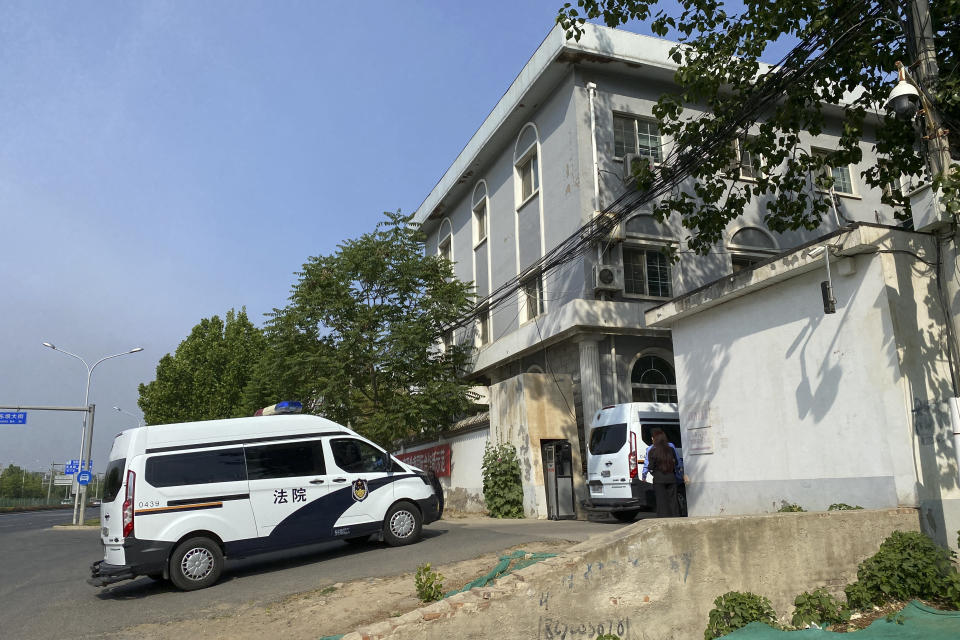 Court police vans move into a courthouse in Beijing, Tuesday, May 11, 2021. Two amateur computer coders taken by police from their Beijing homes last year were standing trial Tuesday in a case that illustrates the Chinese government's growing online censorship and heightened sensitivity to any deviation from the official narrative on its COVID-19 response. (AP Photo/Andy Wong)