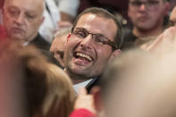 Robert Abela, who will be sworn in as Prime Minister of Malta Monday, is congratulated by a large crowds of supporters inside a volleyball court in Kordin, Malta, Sunday, Jan. 12, 2020. A first-term lawmaker whose father was Malta's president, Abela has been chosen to be the country's prime minister, replacing Joseph Muscat after weeks of protests demanding accountability in the investigation of the car bomb slaying of an anti-corruption journalist who targeted his government. (AP Photo/Rene' Rossignaud)