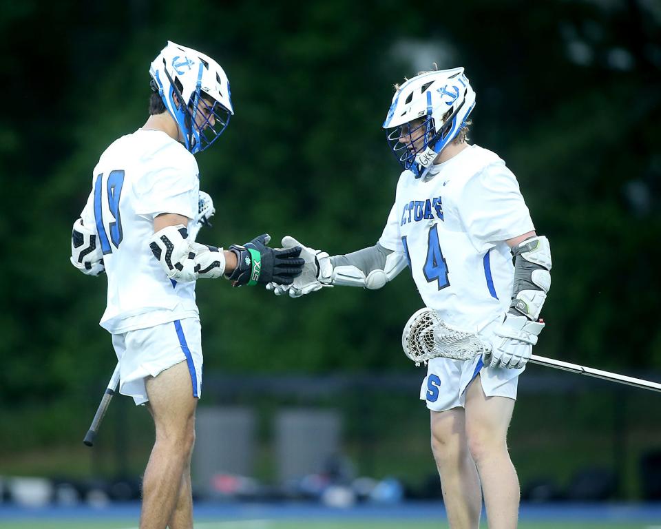 Scituate's Charlie Hartwell and Scituate's Will Robinson share a secret handshake after Charlie scored to give Scituate the 11-2 lead during second quarter action of their game against Whitman-Hanson in the Round of 32 of the Division 2 state tournament at Scituate High School on Tuesday, June 7, 2022. 