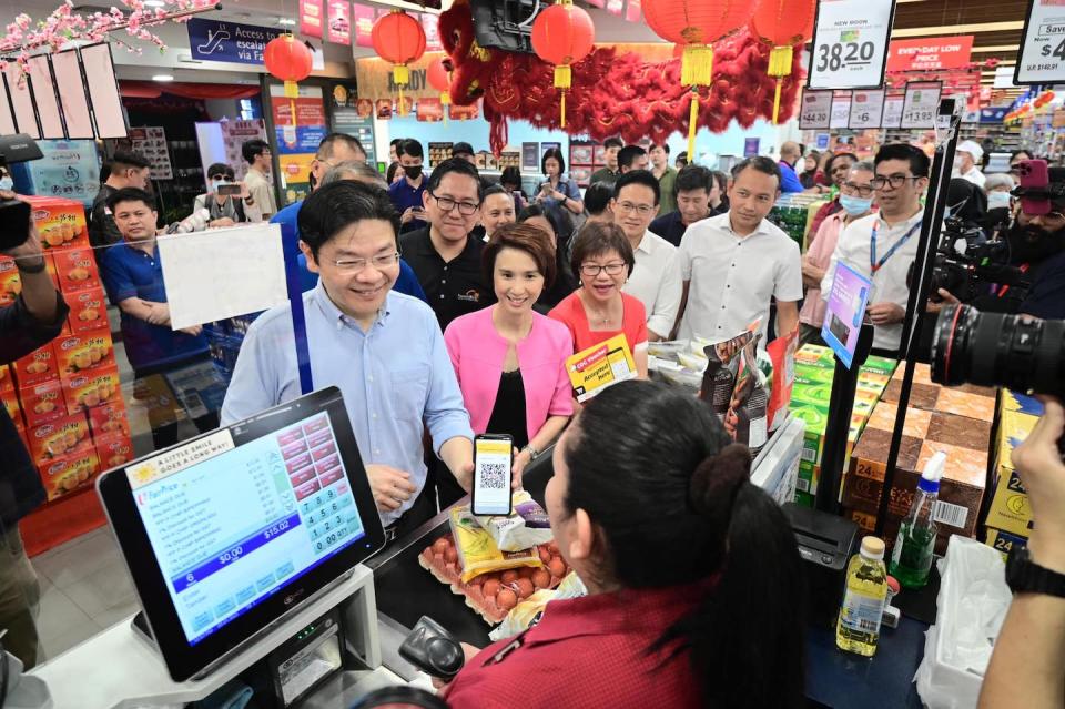 Deputy Prime Minister of Singapore Lawrence Wong using a CDC voucher at a local supermarket.