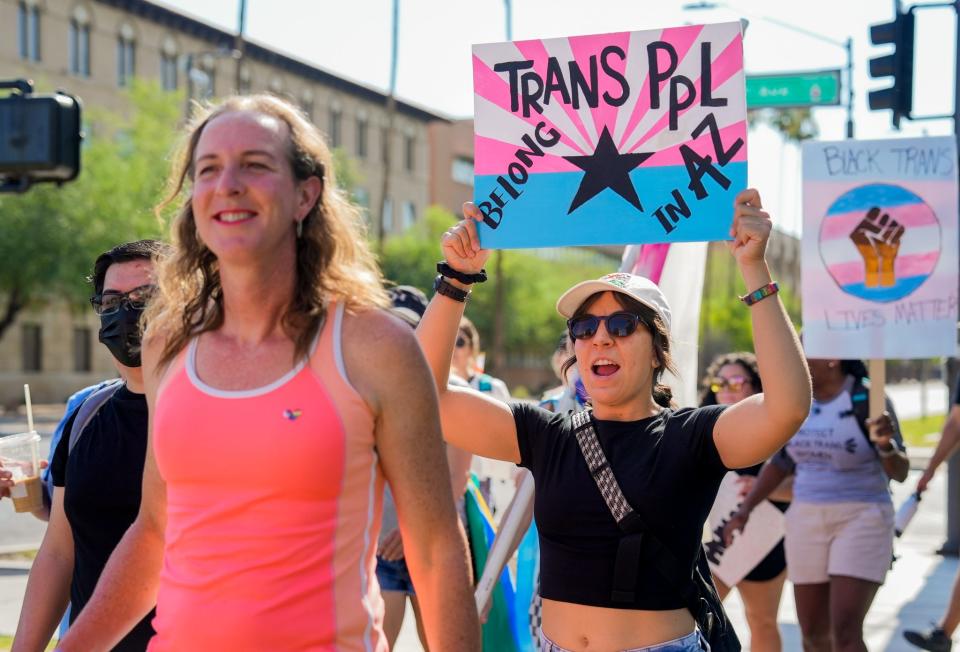 People chant and hold up signs during the March for Trans Justice event by Queerizona at the Arizona Capitol.