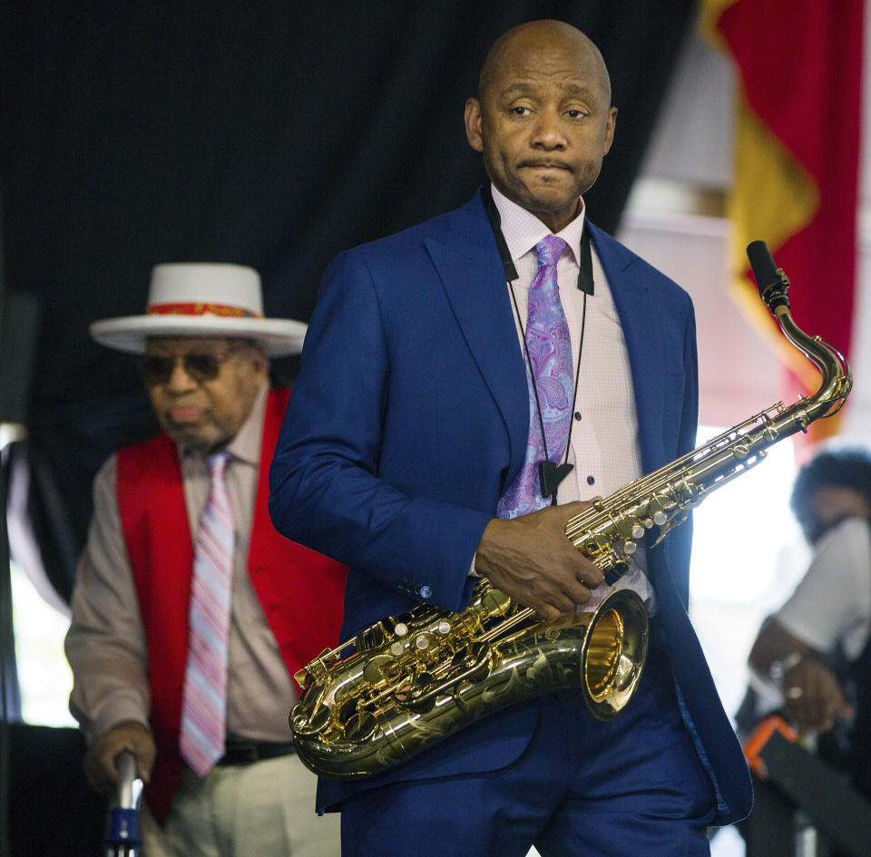 FILE - Branford Marsalis walks onto the stage during the New Orleans Jazz & Heritage Festival in New Orleans, April 28, 2019. Marsalis is taking on a new job in his hometown of New Orleans. Marsalis was to be named Tuesday, Jan. 30, 2024 as the new artistic director for the Ellis Marsalis Center for Music, named for his later father. Ellis Marsalis was the patriarch of a family of accomplished New Orleans musicians that also includes trumpeter Wynton Marsalis. (AP Photo/Sophia Germer, file)