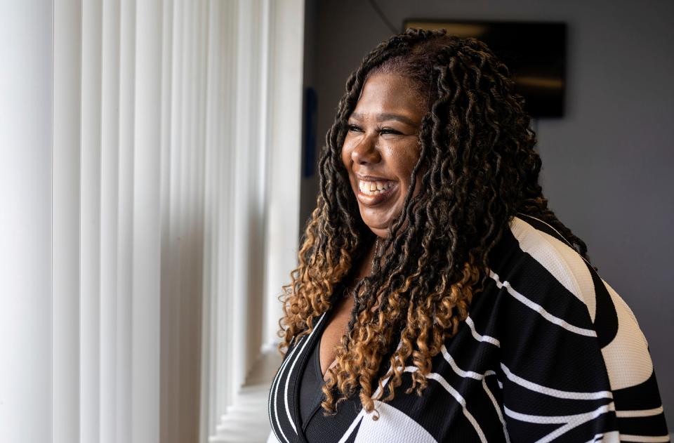 Iesha Morgan, a tax preparer and owner of Tax Stars LLC, smiles as she stands inside the Green Medical Supply LLC in Dearborn on Wednesday, March 20, 2024. Many years ago, Morgan used her tax refund to help start Tax Stars, which she still operates today.