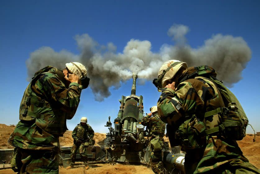 FG.war.arti1.3.27.RL--Iraq--03/27/2003Members of the 1st battalion, 11th Marines, Alpha battery hold their ears upon the release of an artillery round from a 155mm Howitzer headed toward a destination in southern Iraq. LOS ANGELES TIMES PHOTO BY RICK LOOMIS--