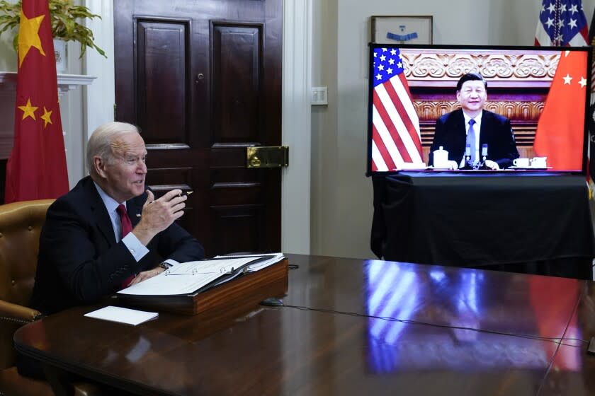 President Joe Biden meets virtually with Chinese President Xi Jinping from the Roosevelt Room of the White House in Washington, Monday, Nov. 15, 2021. (AP Photo/Susan Walsh)