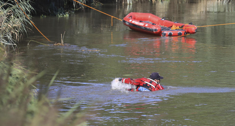 A police officer enters a section of the River Stour during search operations for the missing six-year old boy, Lucas Dobson, who fell into the river Saturday and was swept away while on a fishing trip with family members, in Sandwich, southern England, Monday Aug. 19, 2019. The search for the six-year-old boy resumed Monday, but police have said it is "unlikely" he will be found alive. (Gareth Fuller/PA via AP)