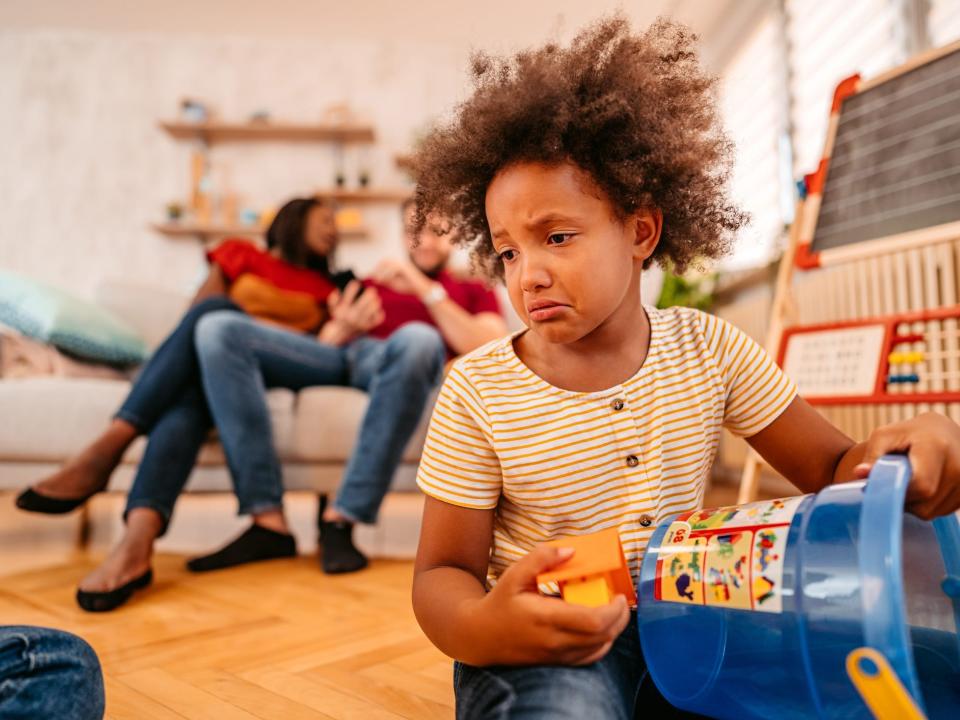 A child crying while their parents ignore them