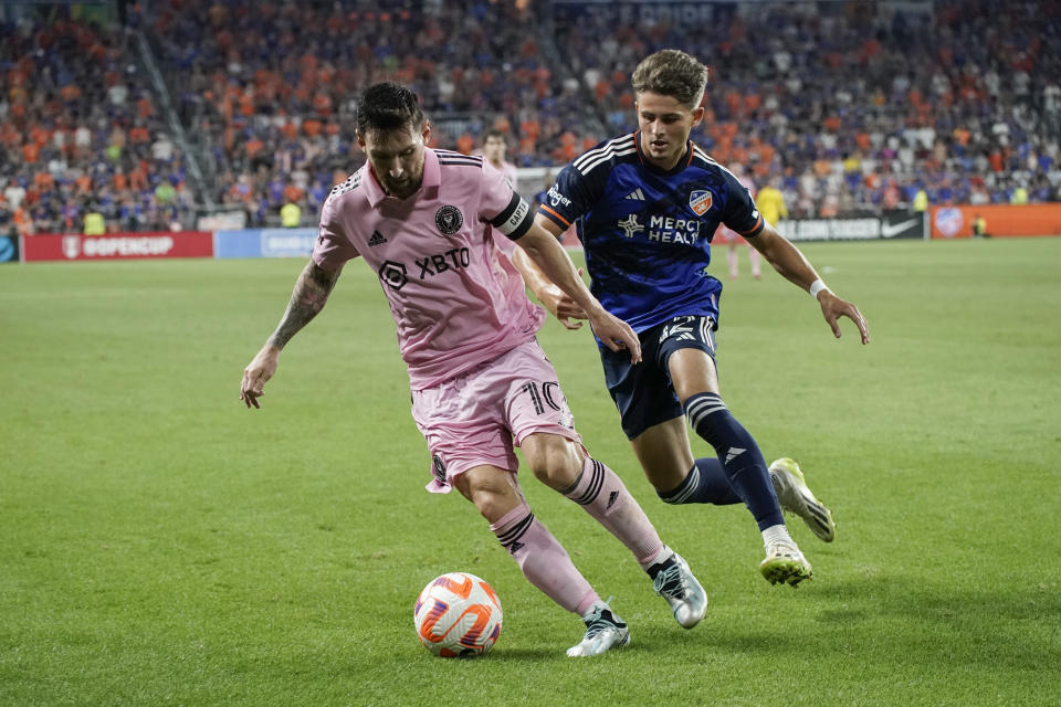 Inter Miami forward Lionel Messi, left, controls the ball next to FC Cincinnati defender Bret Halsey during extra time in a U.S. Open Cup soccer semifinal Wednesday, Aug. 23, 2023, in Cincinnati. (AP Photo/Joshua A. Bickel)