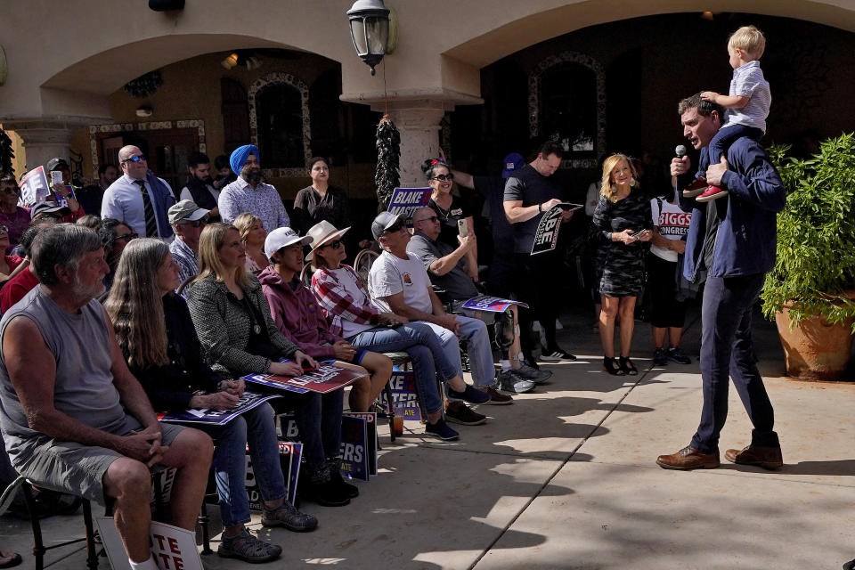 Republican U.S. Senate candidate Blake Masters holds his son, Rex, 2, as he speaks at a rally, Monday, Nov. 7, 2022, in Gilbert, Ariz. (AP Photo/Matt York)