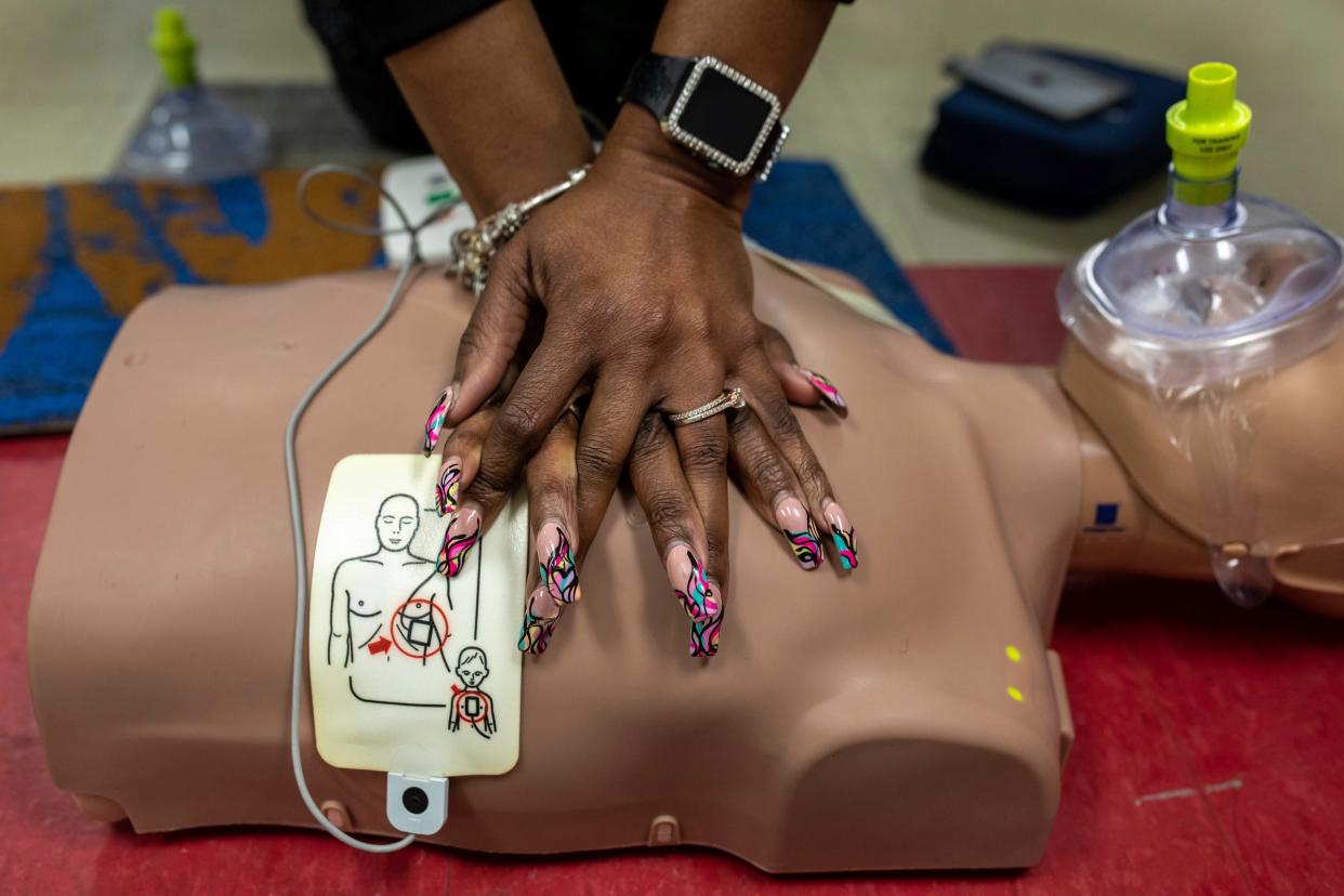 Lei Sean Curtis, 55, an MPH and CPI-certified American Heart Association instructor, performs CPR on a manikin during a CPR class inside the Phlebotomy Express Training Centers in Detroit on Tuesday, March 12, 2024.