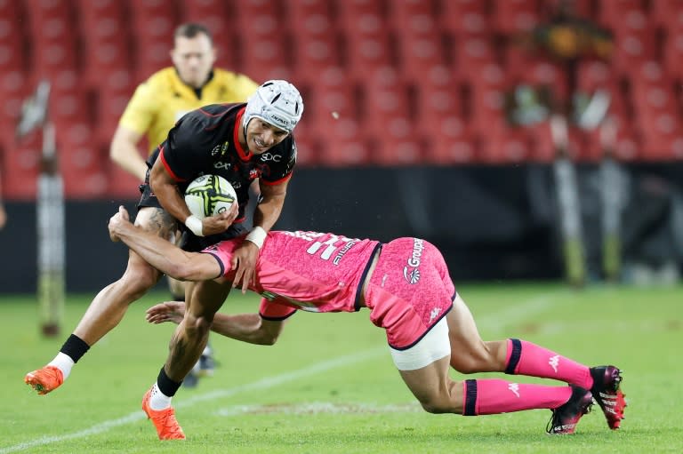 Lions wing Edwill van der Merwe (L) is tackled during a European Challenge Cup against Stade Francais in Johannesburg. (PHILL MAGAKOE)