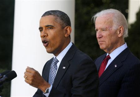 U.S. President Barack Obama stands next to Vice President Joseph Biden while speaking about the enrolment numbers of the Affordable Care Act at the White House in Washington April 1, 2014. REUTERS/Larry Downing