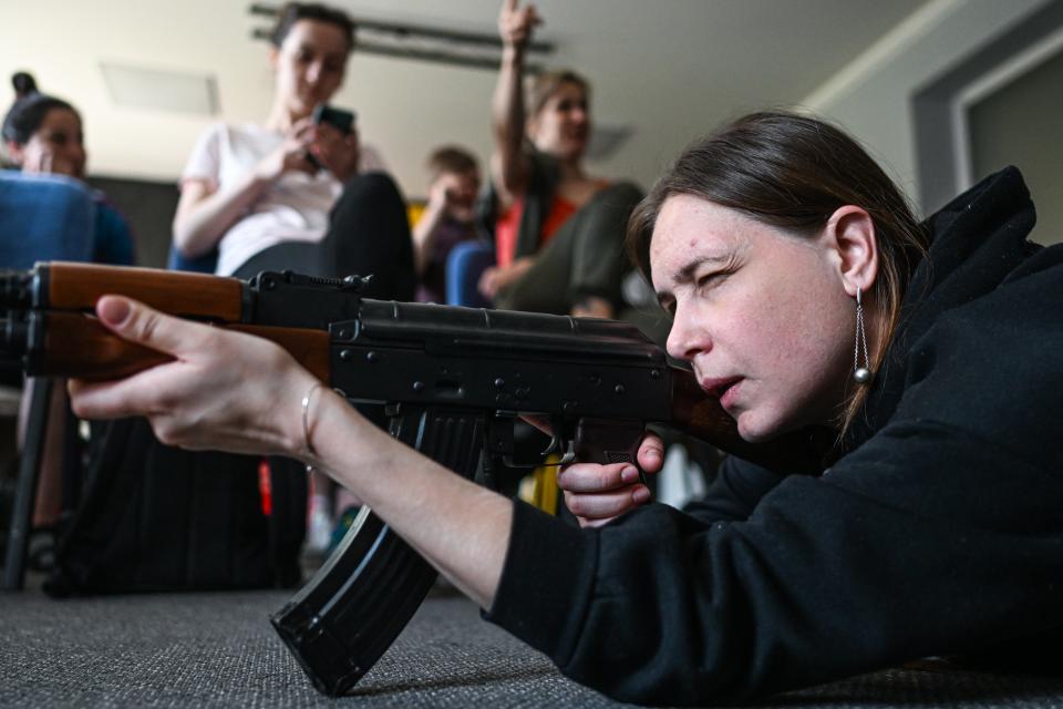 A Ukrainian woman takes aim with a Kalashnikov rifle (Anadolu Agency via Getty Images)