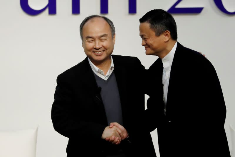 SoftBank Group founder and CEO Masayoshi Son and Alibaba founder and former Chairman Jack Ma shake hands at the Tokyo Forum 2019 in Tokyo