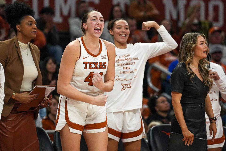 Taylor Jones celebrates on the Texas sideline after a basket. Jones scored 13 points and had a key sequence late in the game, scoring off an offensive rebound and then hustling to the other end to force a turnover.