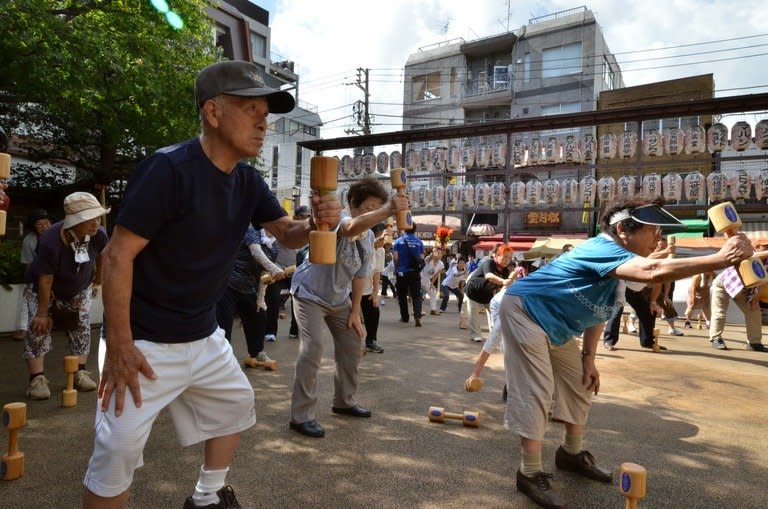 Japanese pensioners work out in the grounds of a temple in Tokyo on September 17, 2012. Japan's finance minister Taro Aso has said the elderly should be allowed to "hurry up and die" instead of costing the government money for end-of-life medical care