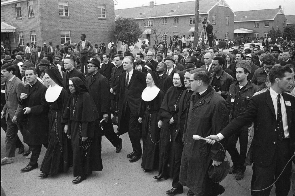 Six Catholic nuns, including Sister Mary Antona Ebo, front row fourth from left, lead a march in Selma, Ala., on March 10, 1965, in support of Black voting rights and in protest of the violence of Bloody Sunday when white state troopers brutally dispersed peaceful Black demonstrators. The group was within a hundred feet of a black church when the police blocked their way. (AP Photo/File)