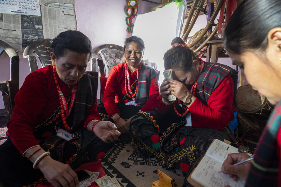 Members of Shrijanshil Mahila Sanstha, or the Self-Reliant Women’s Group, distribute their earnings after playing at a wedding in Kathmandu, Nepal, Thursday, March 7, 2024. A band member earns $30-40 per show. Those who were previously confined to domestic chores say they are happy to see more of the world outside their homes. (AP Photo/Niranjan Shrestha)