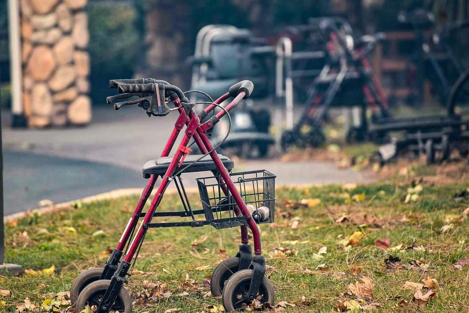 Abandoned walkers covered in ash left behind during an emergency evacuation of a nursing home in Paradise, California, during the 2018 Camp Fire.