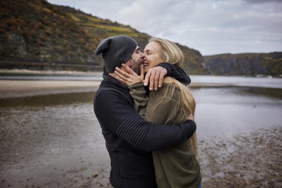 people kissing near lake