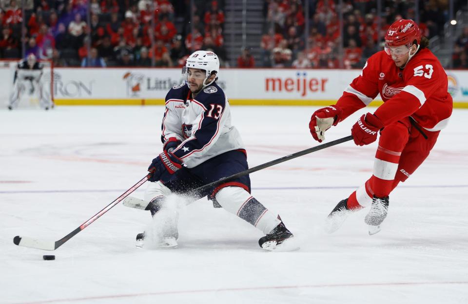 Columbus Blue Jackets left wing Johnny Gaudreau (13) is pursued by Detroit Red Wings defenseman Moritz Seider (53) during the second period of an NHL hockey game Tuesday, March 19, 2024, in Detroit. (AP Photo/Duane Burleson)